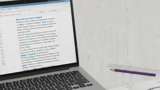 Ноутбук з текстом на екрані, лінійка, олівець та відкрита книга на столі.